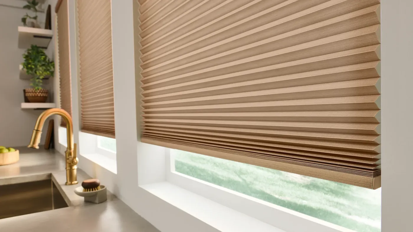Cellular honeycomb shades lowered over kitchen windows