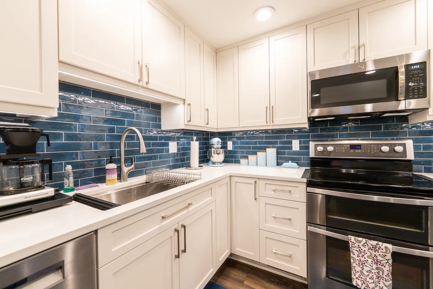 Kitchen with white quartz countertops and a blue backsplash