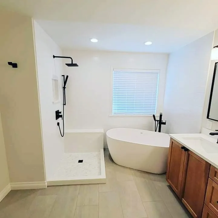 Bright bathroom with freestanding tub and wood vanity