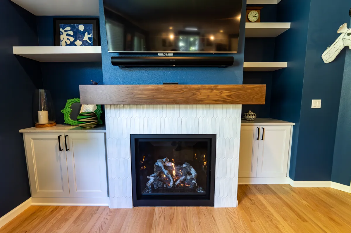 Built-in fireplace surround with floating wood mantel