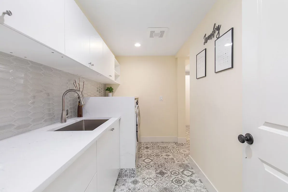 Laundry room with patterned floor tile