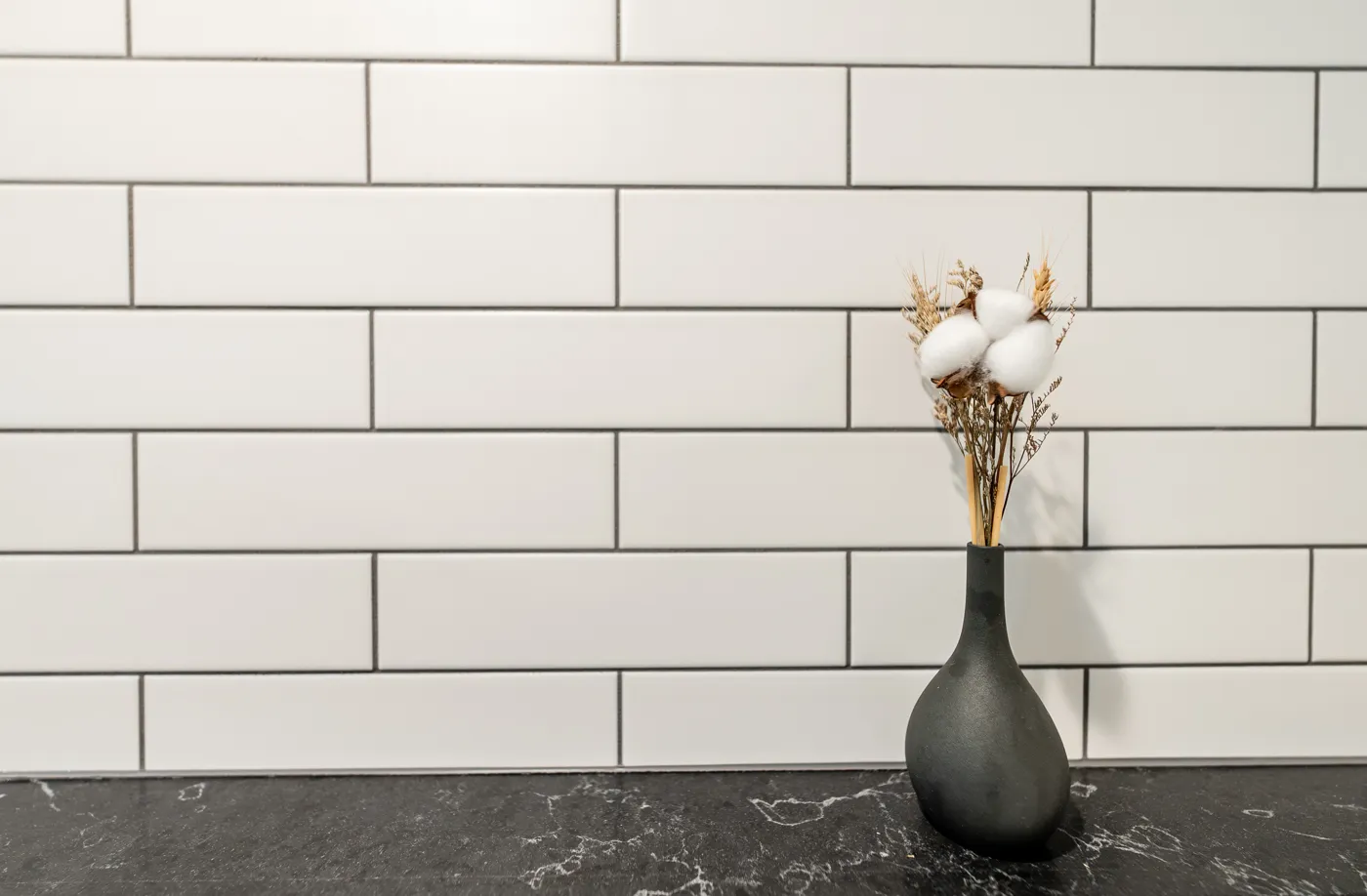 Walk-in shower finished in large-format grey tile