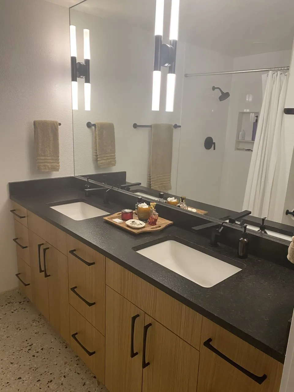 Bathroom with a wood vanity and dark countertop